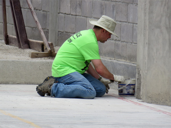 Mike Spitalli making repairs to the concrete wall